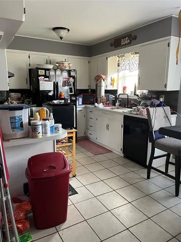 a kitchen with a sink appliances and cabinets
