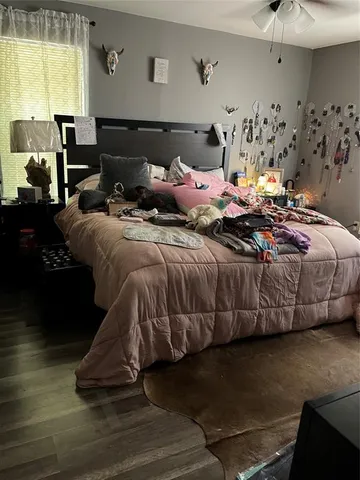 a bedroom with bed and window