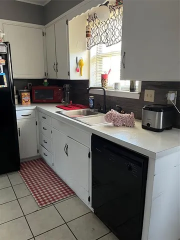 a kitchen with a sink cabinets and window