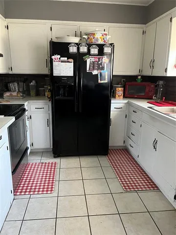 a kitchen with stainless steel appliances granite countertop a refrigerator and a stove