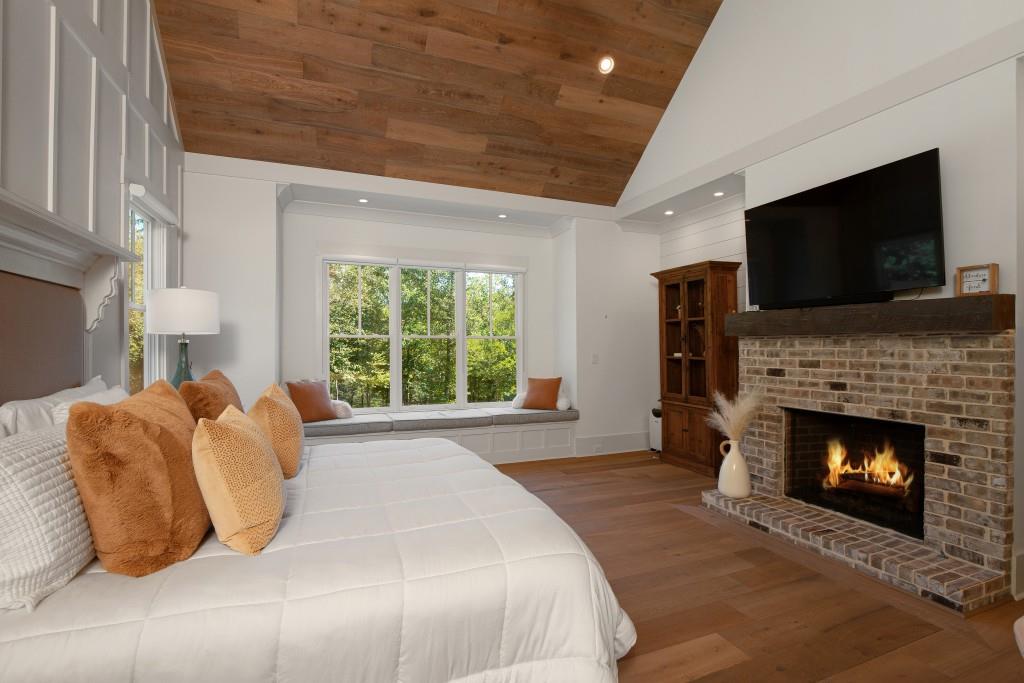 13235 Arnold Mill Road Roswell, GA 30075 - Photo 24 of 72 a bedroom with a bed and a fireplace