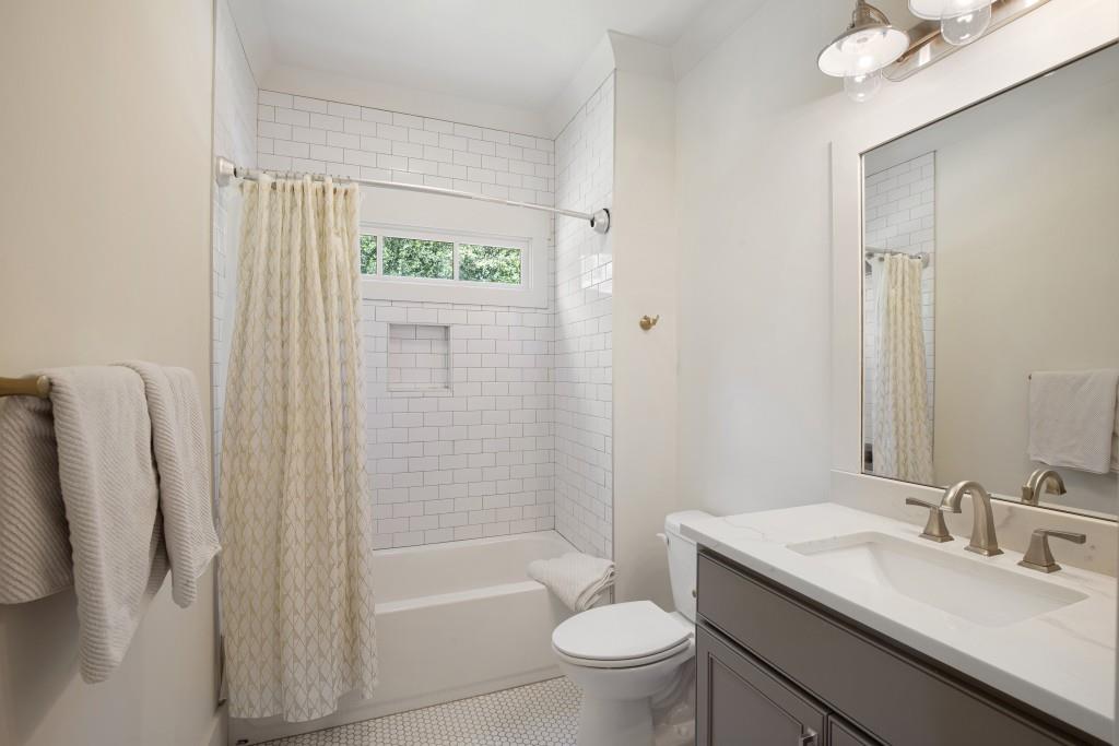 13235 Arnold Mill Road Roswell, GA 30075 - Photo 31 of 72 a bathroom with a granite countertop sink toilet and shower