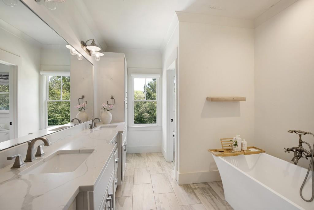13235 Arnold Mill Road Roswell, GA 30075 - Photo 34 of 72 a spacious bathroom with a tub a sink and mirror