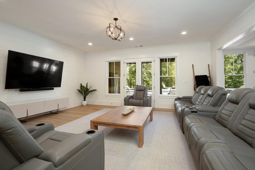 13235 Arnold Mill Road Roswell, GA 30075 - Photo 36 of 72 a living room with furniture and a flat screen tv
