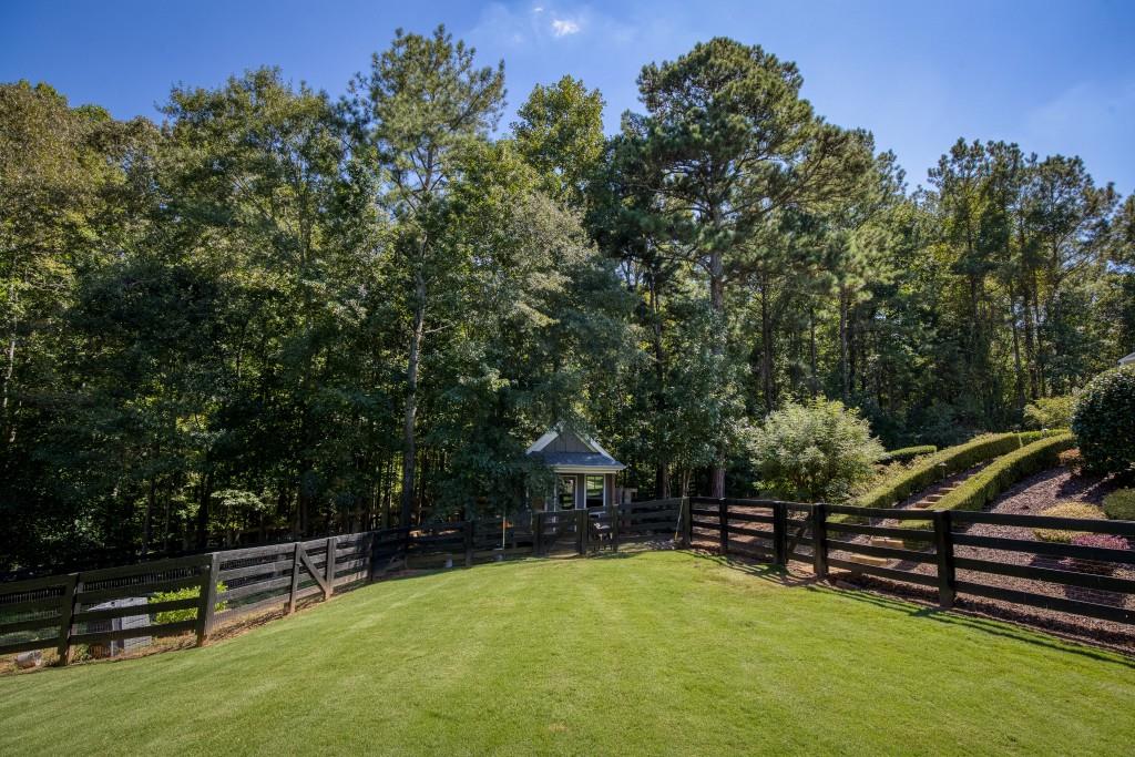 13235 Arnold Mill Road Roswell, GA 30075 - Photo 60 of 72 a view of a swimming pool with a bench and wooden fence