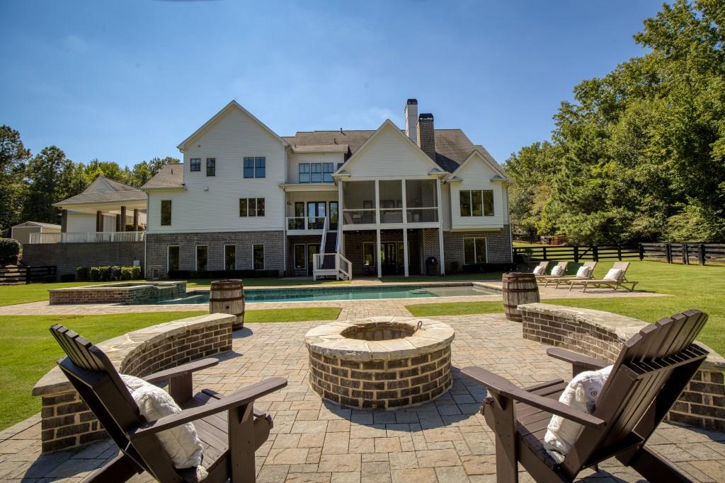 13235 Arnold Mill Road Roswell, GA 30075 - Photo 63 of 72 a view of a house with swimming pool and a chairs
