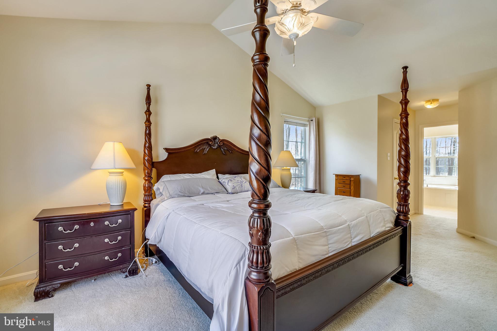 8004 Big Pool Road Laurel, MD 20724 - Photo 17 of 39 a bedroom with a bed and a chandelier