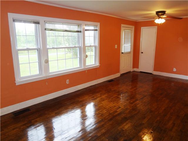 202 Johnson Branch Road Pulaski, TN 38478 - Photo 6 of 16 This large living room offers hardwood floors and an old fireplace. With a little work this fireplace could be a nice show piece of the house.
