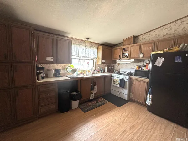 a kitchen with a sink window and cabinets