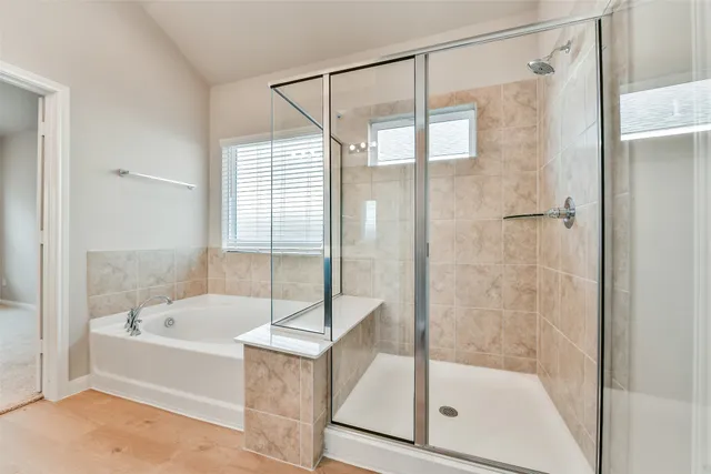 a bathroom with a bathtub and a shower