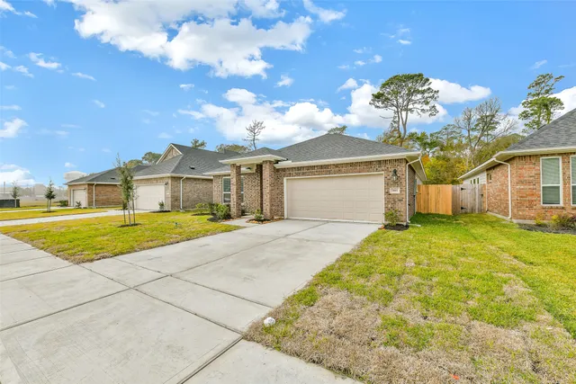 a view of a house with a backyard and a garage