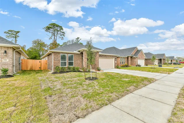 a swimming pool with yard and wooden fence
