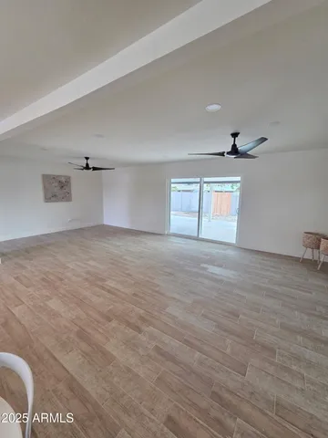 a kitchen with stainless steel appliances kitchen island granite countertop a refrigerator and cabinets