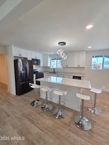 a view of a room with wooden floor and cabinet