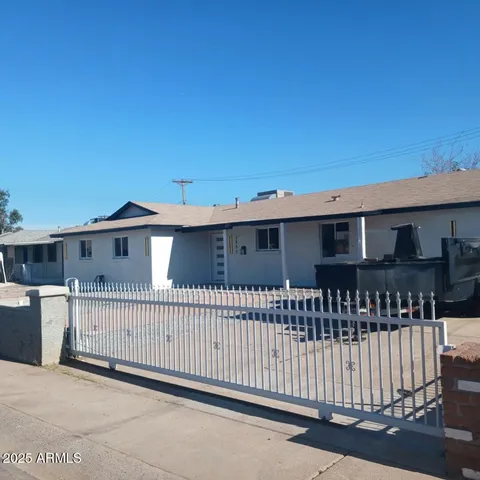 a view of a house with wooden fence