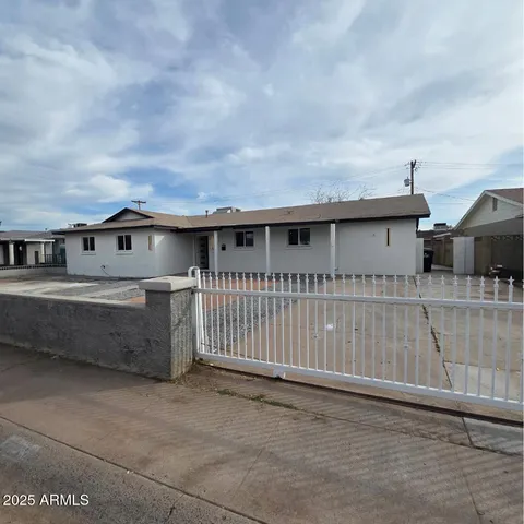 a side view of a house with a wooden fence