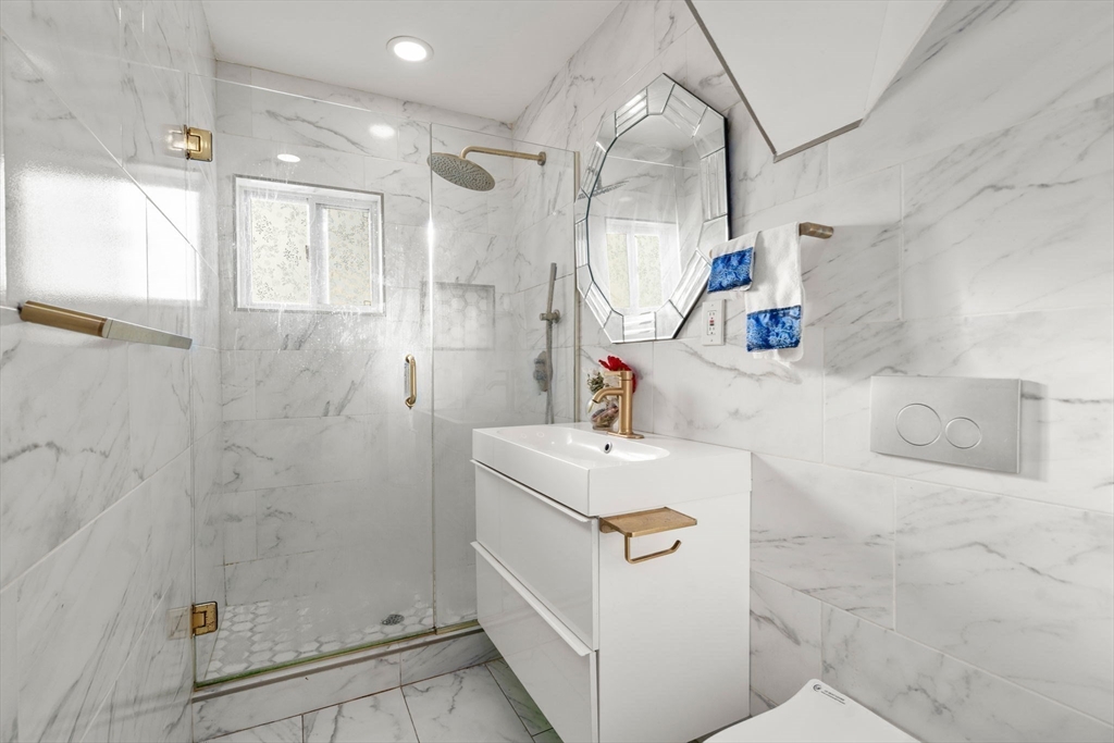 7 Sidney Avenue Lynn, MA 01902 - Photo 12 of 15 a bathroom with a sink a toilet and shower