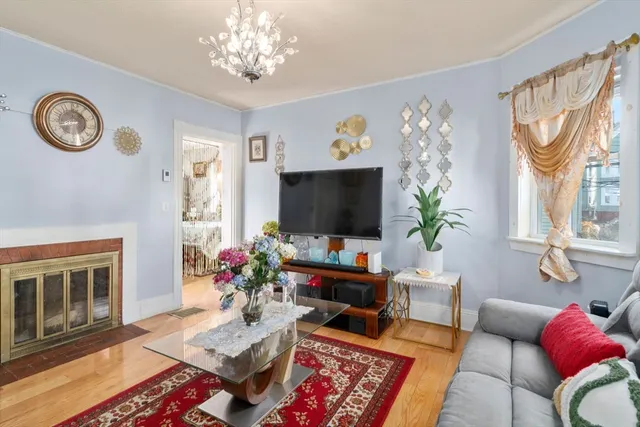 a living room with furniture a flat screen tv and a table