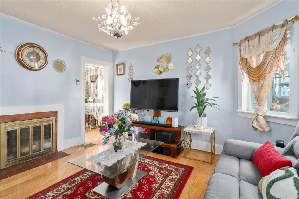 7 Sidney Avenue Lynn, MA 01902 - Photo 3 of 15 a living room with furniture a flat screen tv and a table