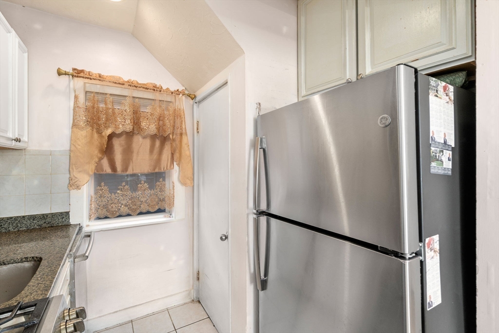 7 Sidney Avenue Lynn, MA 01902 - Photo 6 of 15 a white refrigerator freezer sitting inside of a kitchen