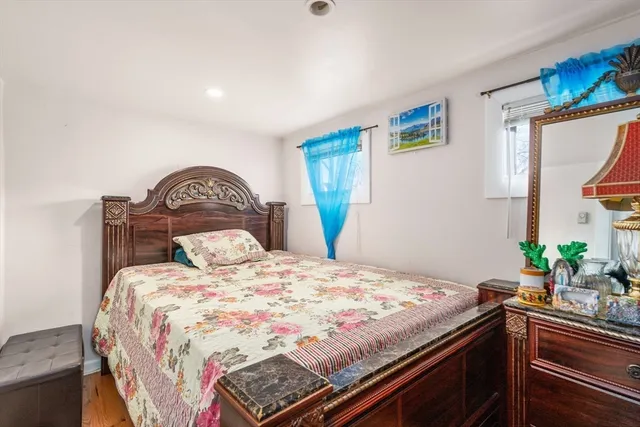 a bedroom with a bed and a potted plant