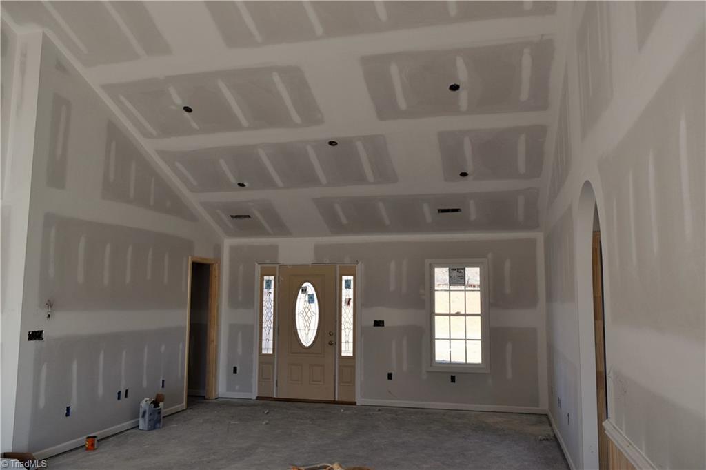 7909 Lester Road Stokesdale, NC 27357 - Photo 6 of 30 Living room with coat closet to left 1-6-21