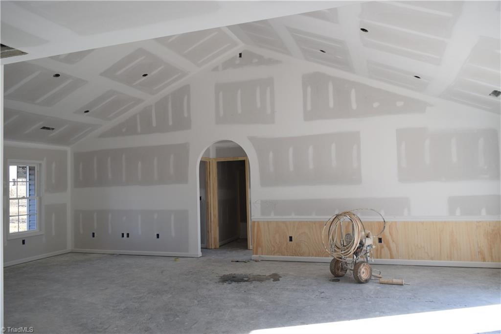 7909 Lester Road Stokesdale, NC 27357 - Photo 8 of 30 Open living room and dining with vaulted ceiling 1-6-21