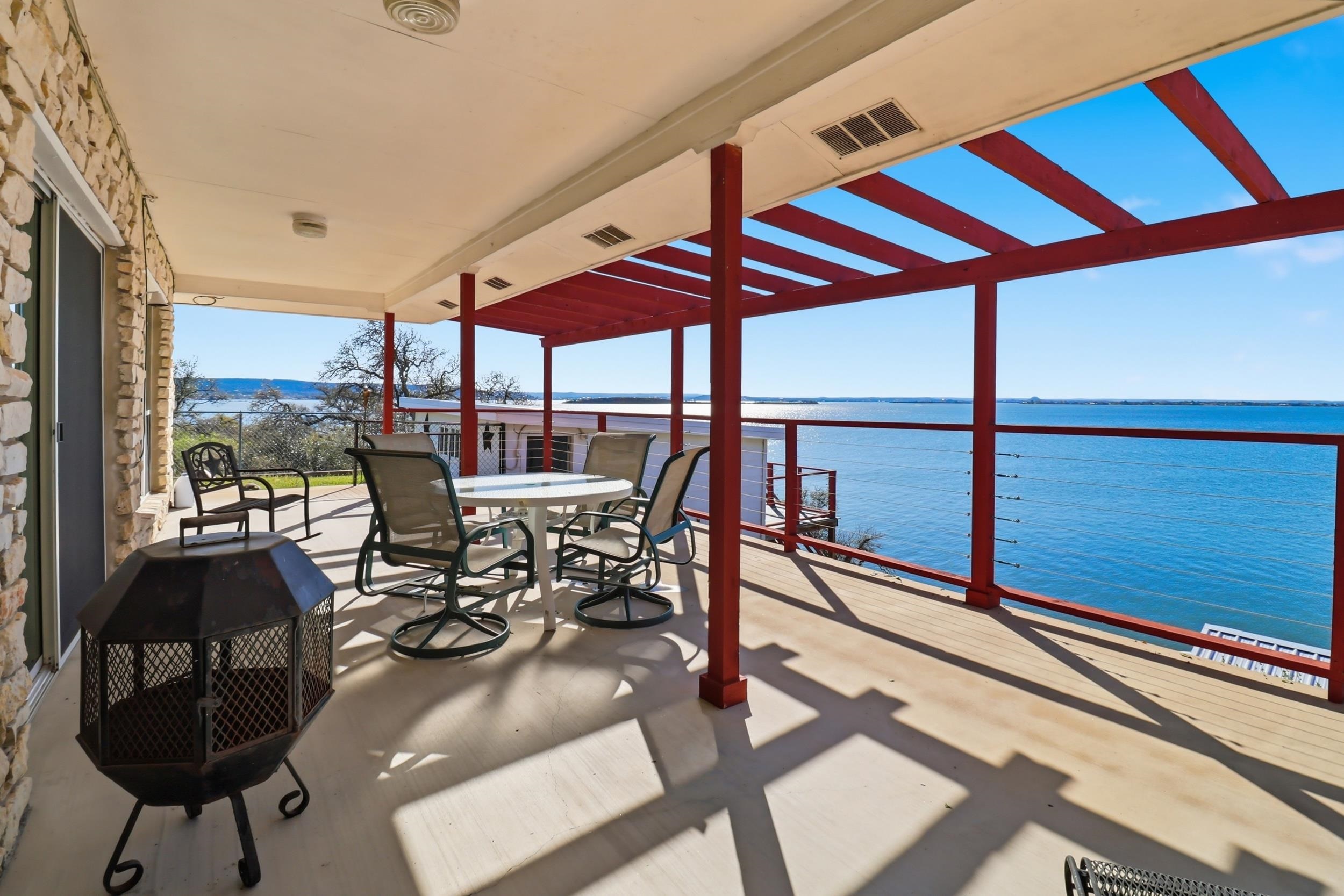 919 Lakeshore Loop Tow, TX 78672 - Photo 11 of 33 a view of a balcony with chairs and wooden floor
