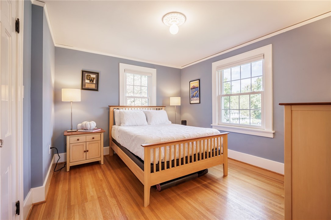 387 Kilbourn Road Rochester, NY 14618 - Photo 26 of 42 Bedroom #2Rich hardwood floors and classic crown molding elevate this serene bedroom filled with natural light.