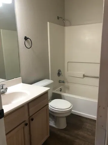 a bathroom with a toilet sink and a mirror