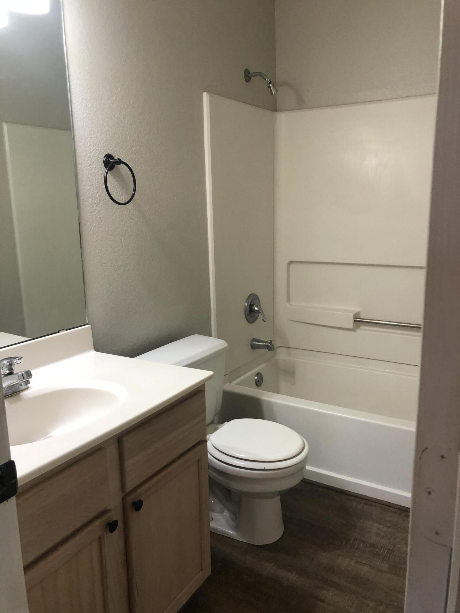 5102 80th Street Lubbock, TX 79424 - Photo 15 of 20 a bathroom with a toilet sink and a mirror
