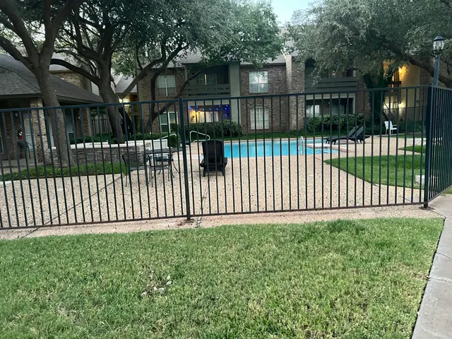 a view of a white house in the back yard