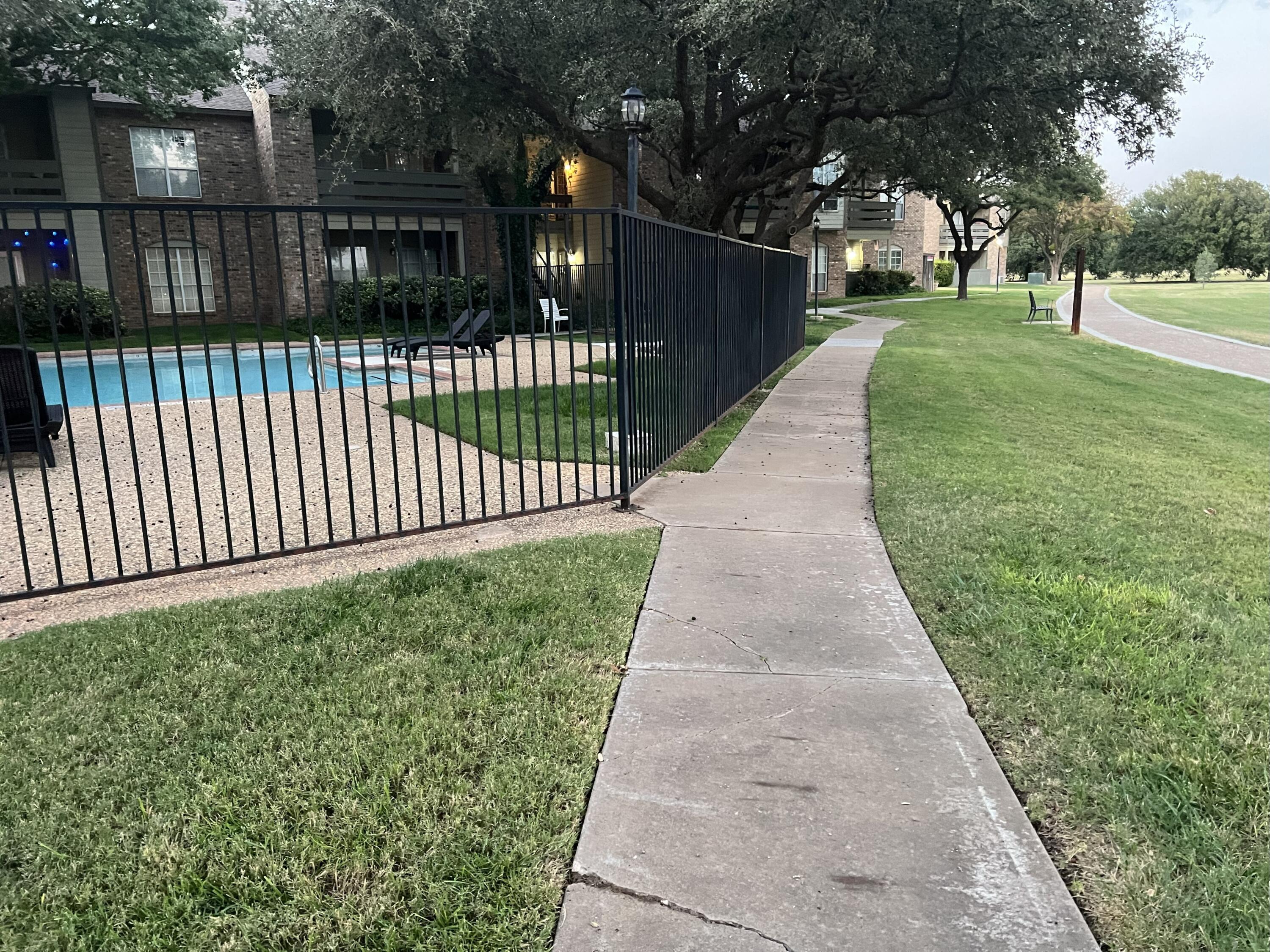 5102 80th Street Lubbock, TX 79424 - Photo 18 of 20 a view of a backyard with wooden fence
