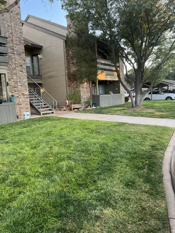 a view of a house with a backyard