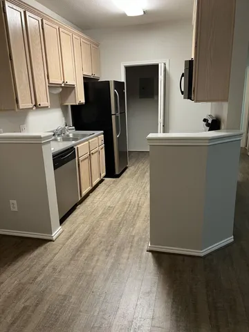 a kitchen with stainless steel appliances a refrigerator sink and microwave