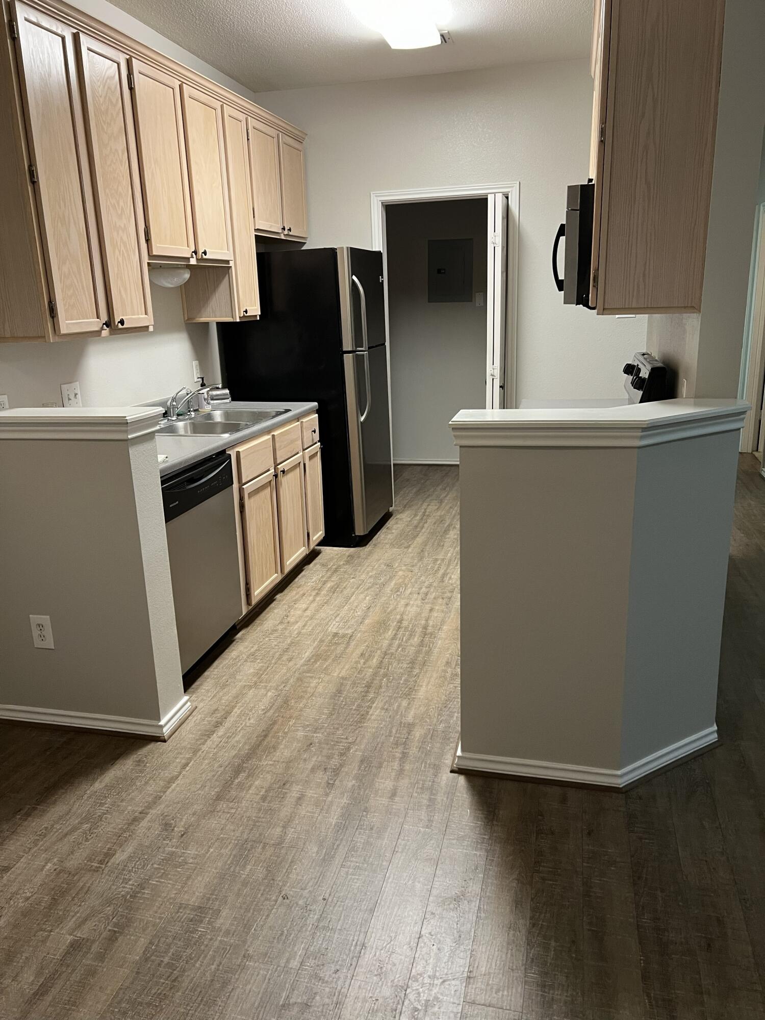5102 80th Street Lubbock, TX 79424 - Photo 6 of 20 a kitchen with stainless steel appliances a refrigerator sink and microwave