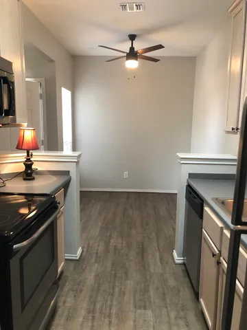 a kitchen with granite countertop a stove and a sink