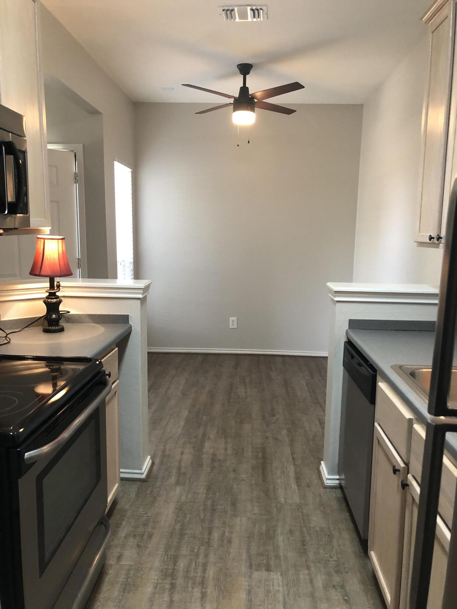 5102 80th Street Lubbock, TX 79424 - Photo 8 of 20 a kitchen with granite countertop a stove and a sink