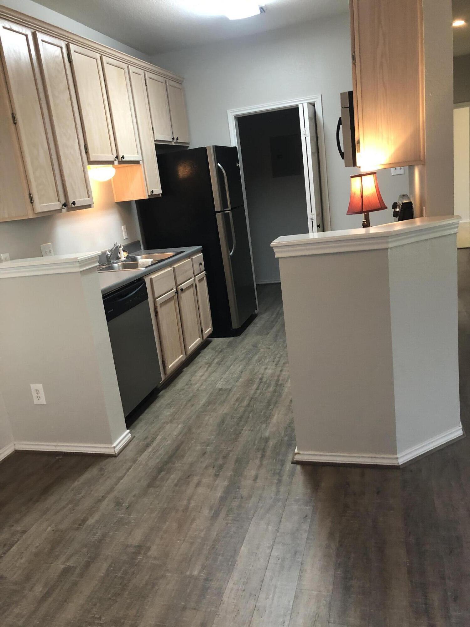 5102 80th Street Lubbock, TX 79424 - Photo 9 of 20 a kitchen with stainless steel appliances a refrigerator and a sink