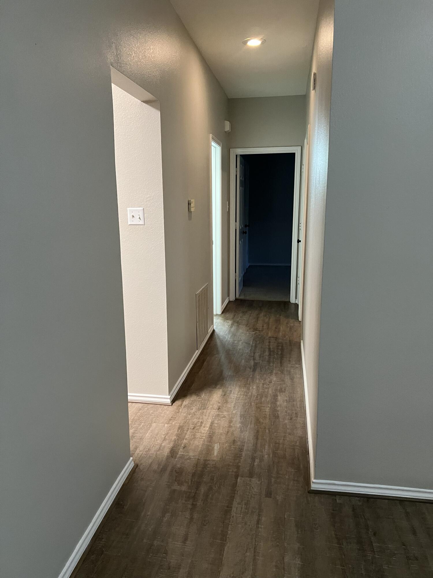 5102 80th Street Lubbock, TX 79424 - Photo 10 of 20 an empty room with wooden floor and entrance