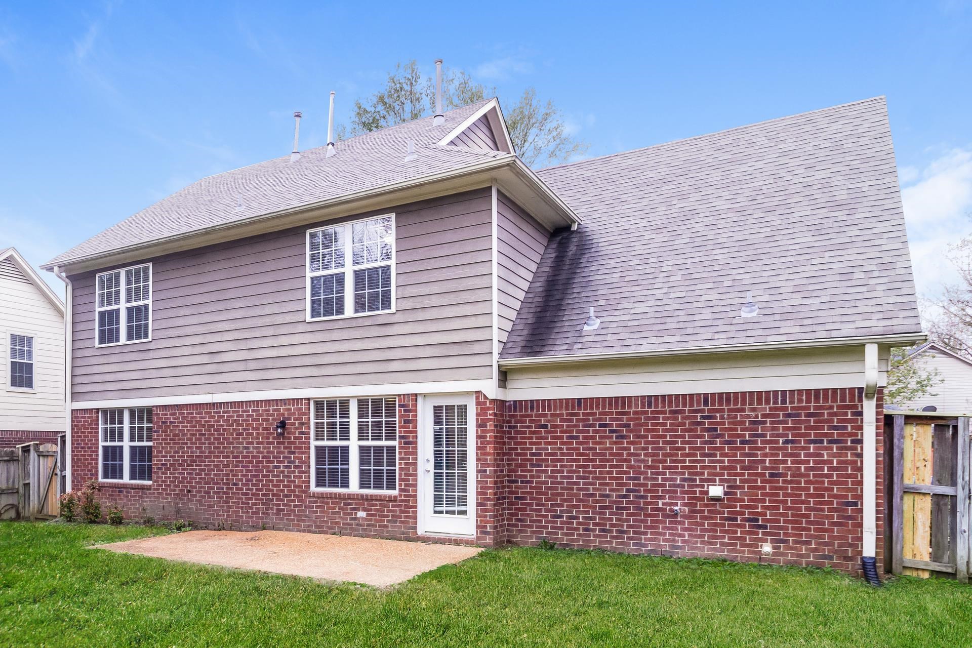 5368 Milton Ridge Drive Arlington, TN 38002 - Photo 14 of 17 Back of house with roof with shingles, a patio, and brick siding