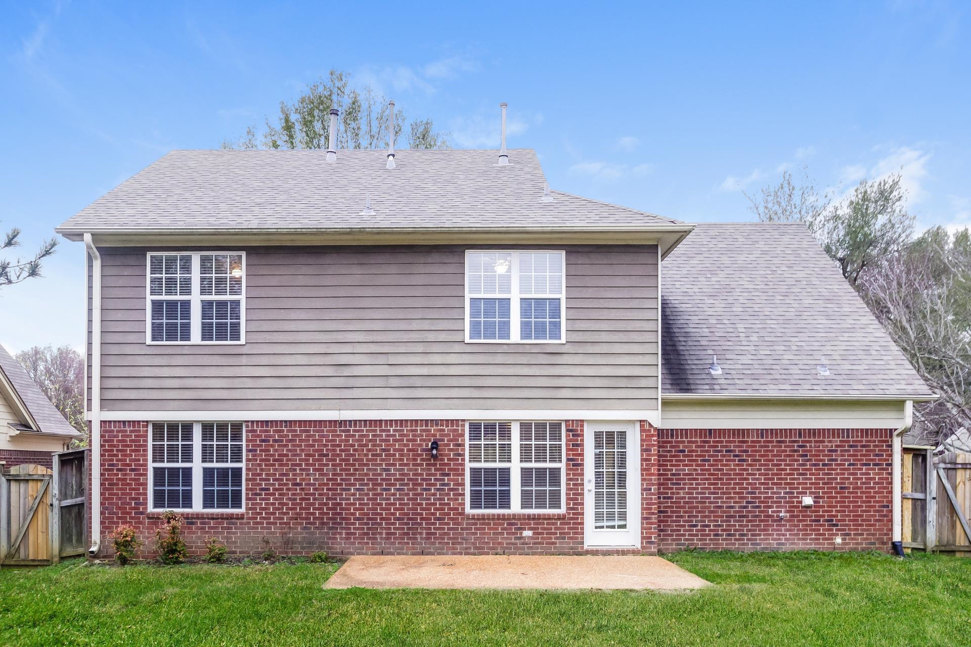 5368 Milton Ridge Drive Arlington, TN 38002 - Photo 15 of 17 Back of property featuring a gate, brick siding, a patio area, and a fenced backyard