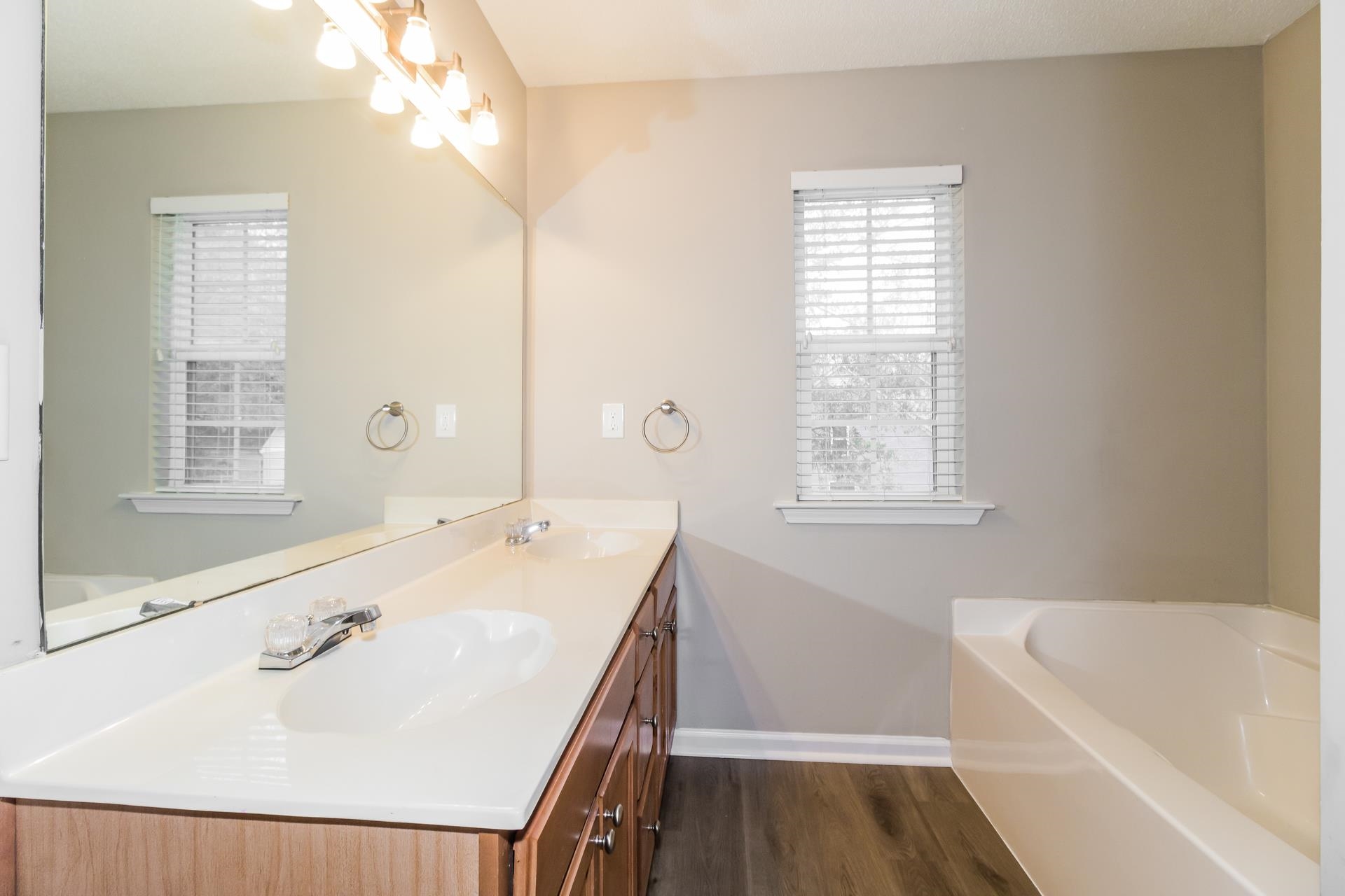 5368 Milton Ridge Drive Arlington, TN 38002 - Photo 10 of 17 Bathroom featuring a bath, double vanity, and dark wood-style flooring