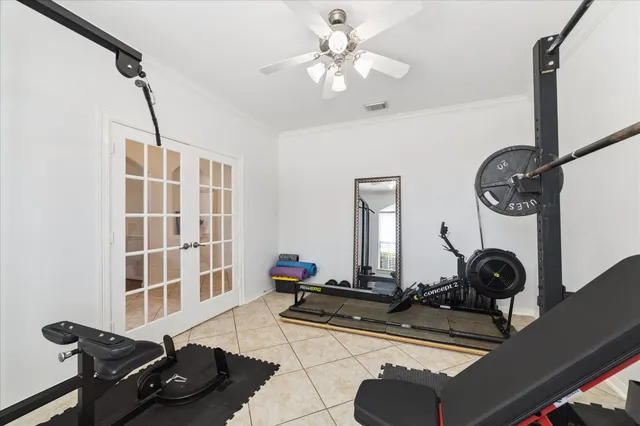 a room with gym equipment and view of living room