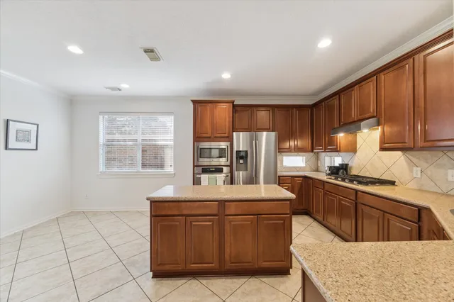 a kitchen with stainless steel appliances granite countertop a sink stove and cabinets