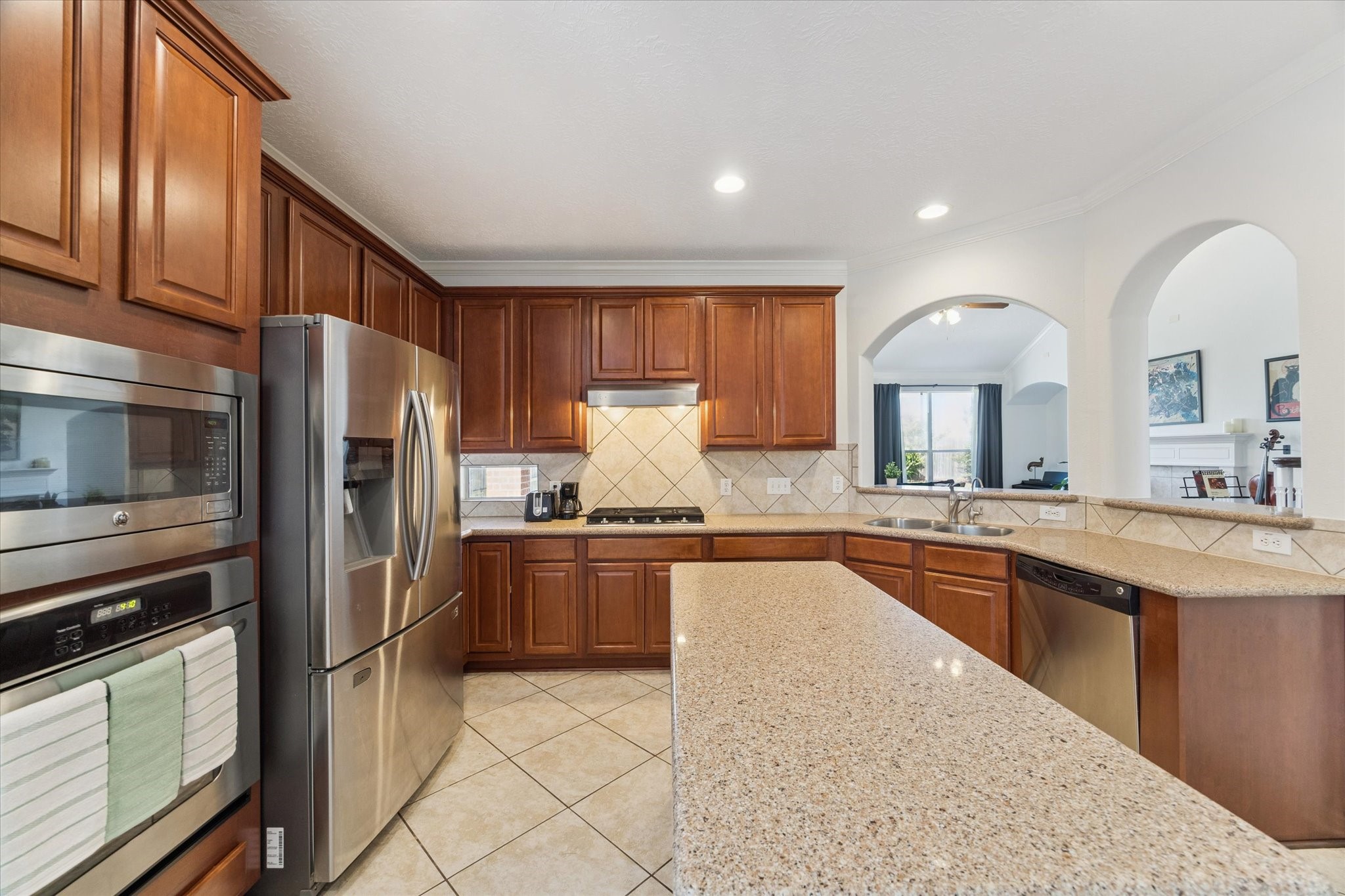 5315 Maverick Point Lane Katy, TX 77494 - Photo 4 of 29 a large kitchen with stainless steel appliances granite countertop a stove refrigerator sink and cabinets