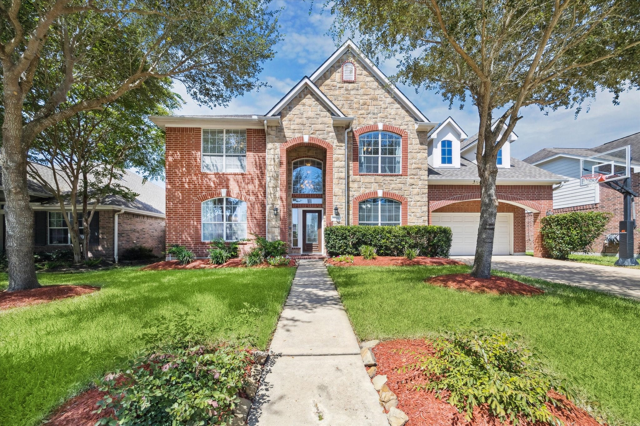 5315 Maverick Point Lane Katy, TX 77494 - Photo 7 of 29 a front view of a house with a yard and potted plants