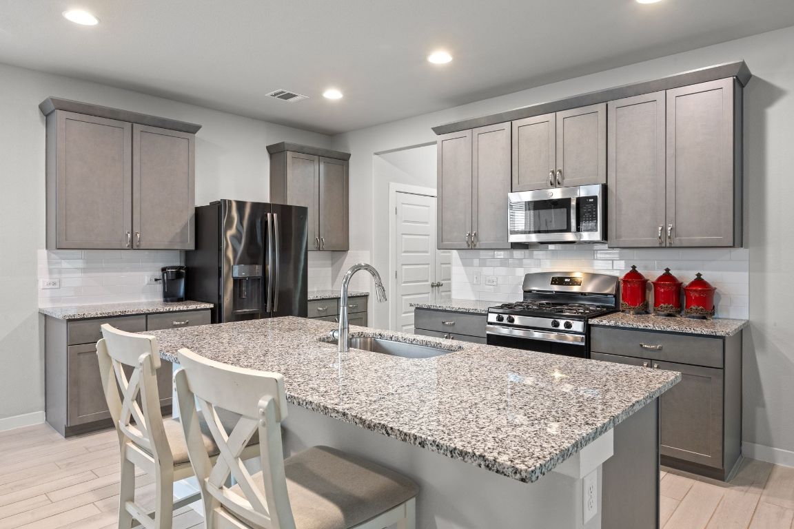 161 Appleberry Lane Elgin, TX 78621 - Photo 12 of 40 Upgraded Amesbury Shaker Mist cabinetry.