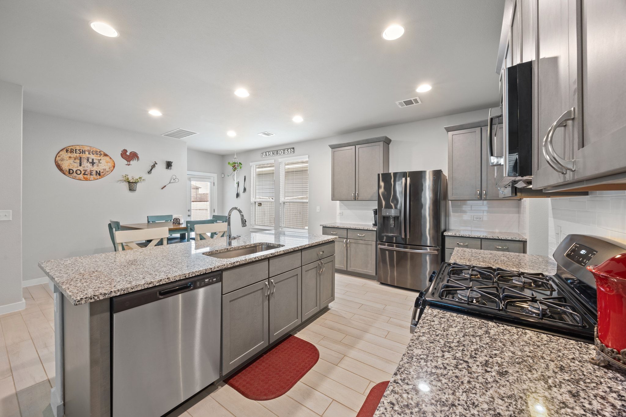 161 Appleberry Lane Elgin, TX 78621 - Photo 14 of 40 a kitchen with stainless steel appliances granite countertop a sink stove and refrigerator