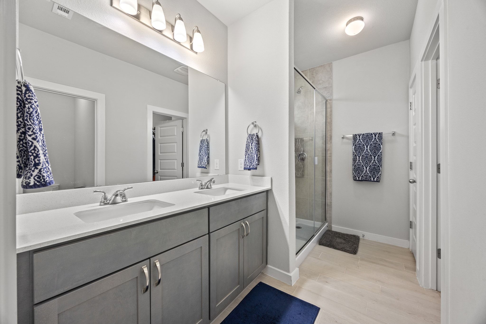 161 Appleberry Lane Elgin, TX 78621 - Photo 22 of 40 a en suite bathroom with a double vanity sink a mirror and a shower